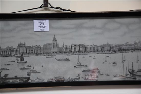 A Chinese machine embroidered silk picture of the river front of Shanghai, 1930s, 18.5 x 84cm., framed and glazed